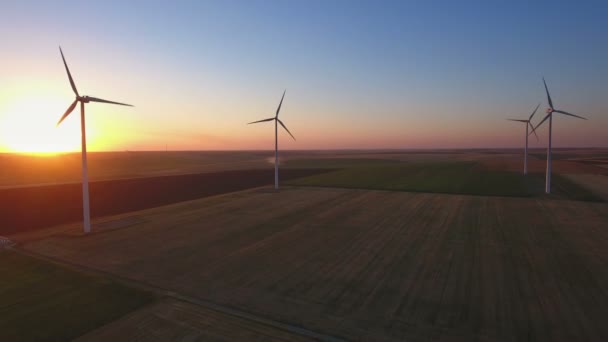 Aerial view of cluster of wind turbines in rural agriculture field. — Stock Video