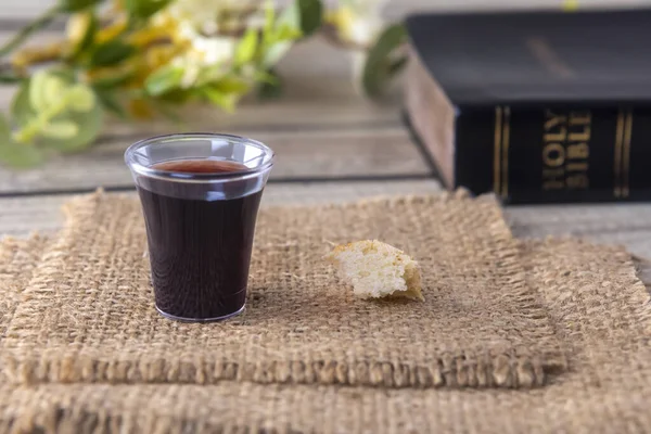 Taking communion concept - the wine and the bread symbols of Jesus Christ blood and body. Easter Passover and Lord Supper concept Focus on bread.