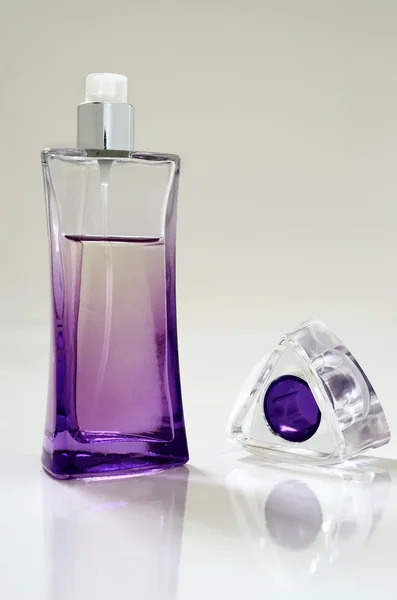 Lilac perfume bottle and cap removed — Stock Photo, Image