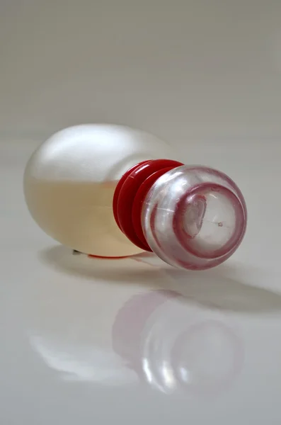 Yellow perfume bottle laying — Stock Photo, Image