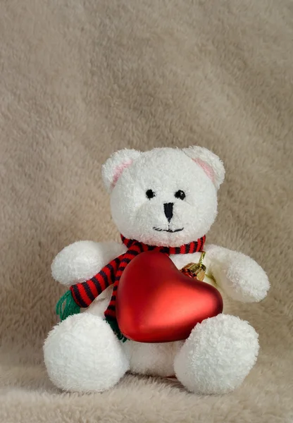 Weißer Teddybär sitzt mit rotem Herz — Stockfoto