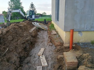 İnşaat alanında inşaat halindeki bireysel eve yakın drenaj kanalı