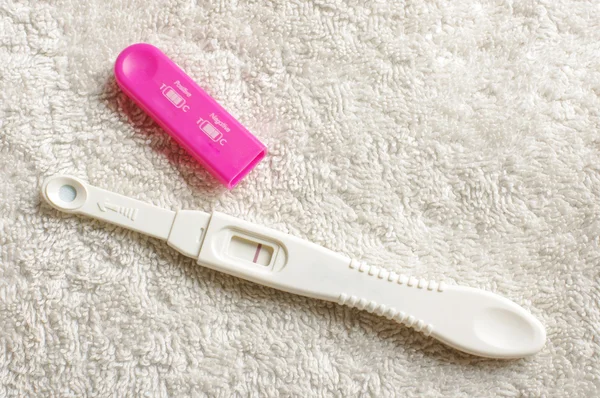 Negatieve zwangerschapstest op de witte handdoek Stockfoto
