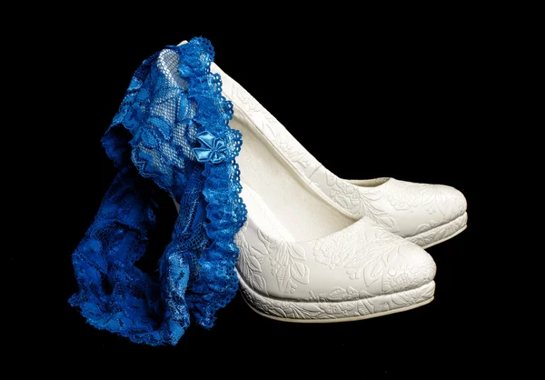 Blue wedding garter on the pair of bridal shoes — Stock Photo, Image