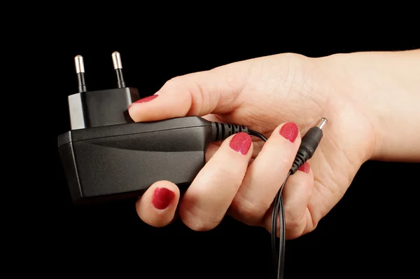 Female hand holding AC charger adapter — Stock Photo, Image