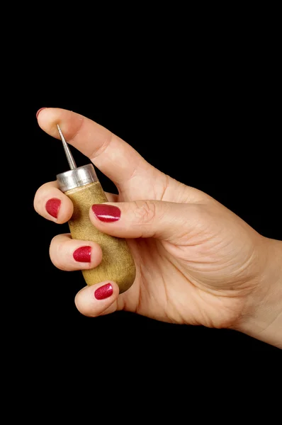 Female hand prick the finger with awl — Stock Photo, Image