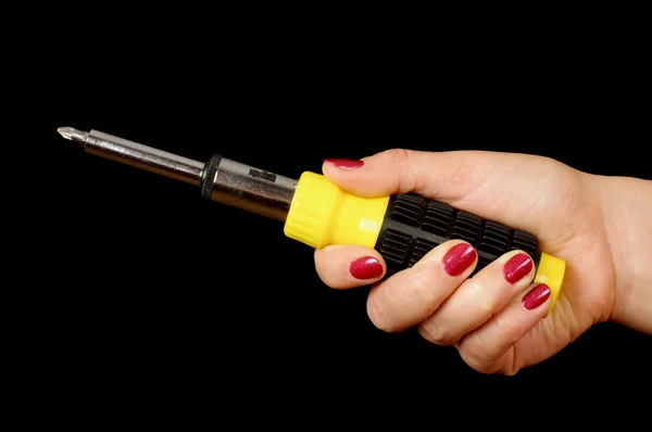 Female hand holding screwdriver isolated on the black background — Stock Photo, Image