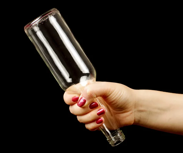 Woman hand holding bottle by it's bottleneck — Stock Photo, Image