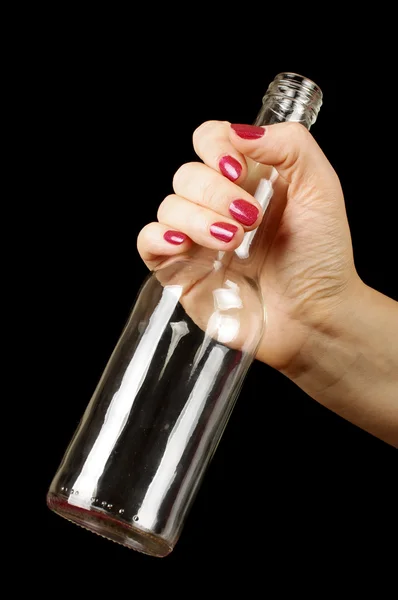 Mano femminile tenuta bottiglia di vodka vuota isolato — Foto Stock