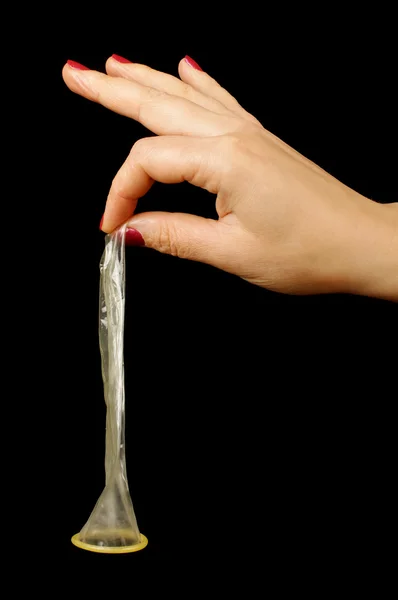 Female hand holding condom isolated — Stock Photo, Image