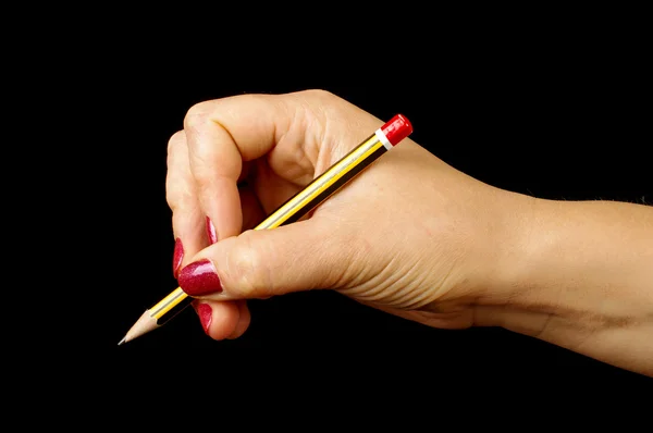 Kobieta ręka trzyma ołówek na czarnym tle Zdjęcie Stockowe