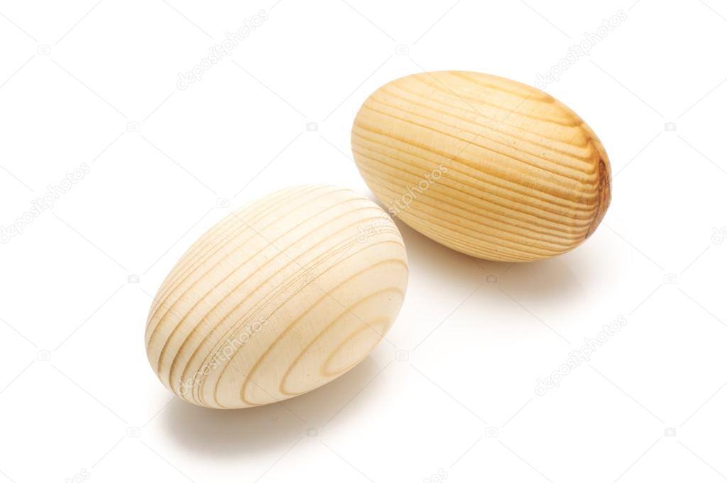 Artificial wooden eggs isolated on the white background