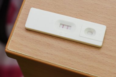 ahşap masa üzerinde pozitif gebelik testi