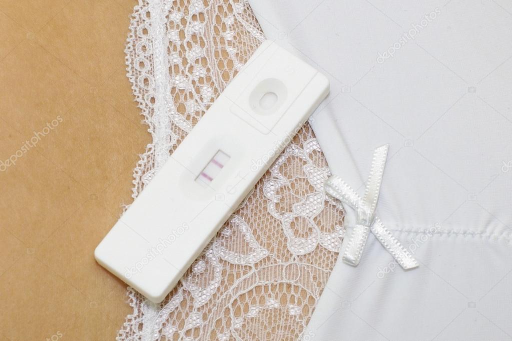 Positive pregnancy test on the woman belly