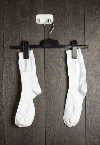 Two white socks hanged on the wall — Stock Photo, Image