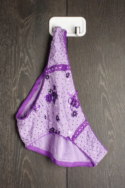 Violet color bikini on the hook — Stock Photo, Image