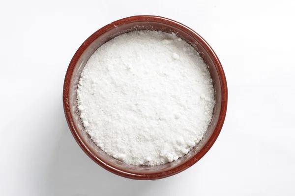 A bowl of common salt isolated on the bright background — Stock Photo, Image