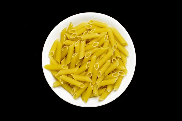 Bowl full of raw penne rigate pasta isolated — Stock Photo, Image