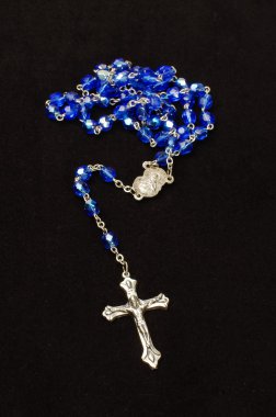 Silver cross crucifix and blue glass rosary isolated clipart