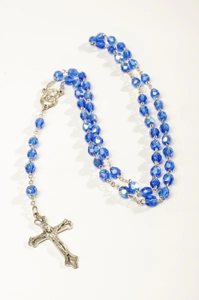 Blue rosary isolated on the bright background — Stock Photo, Image
