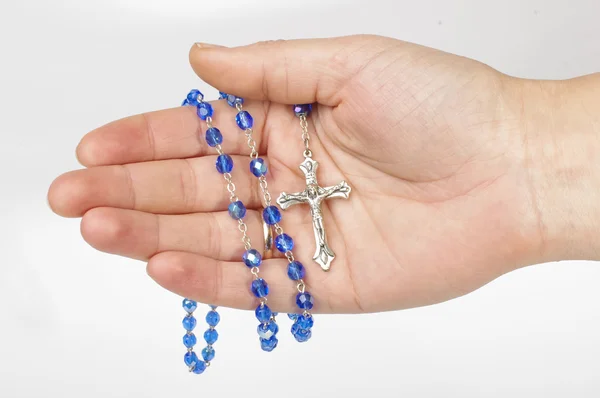 Blue rosary in female palm isolated — Stock Photo, Image