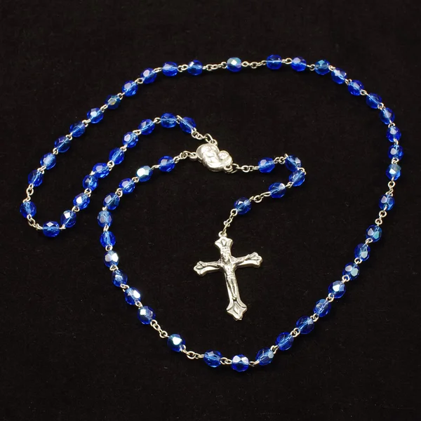 Holy rosary with Christian cross isolated on the dark background — Stock Photo, Image