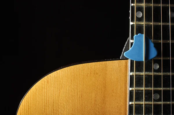 Close up of beautiful guitar body and blue guitar pick — Stock Photo, Image