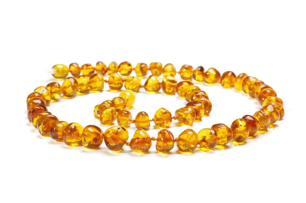 Amber necklace in spiral isolated on the white background — Stock Photo, Image