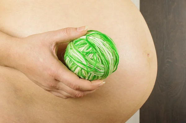 Pregnant female holding ball of wool yarns — Stock Photo, Image