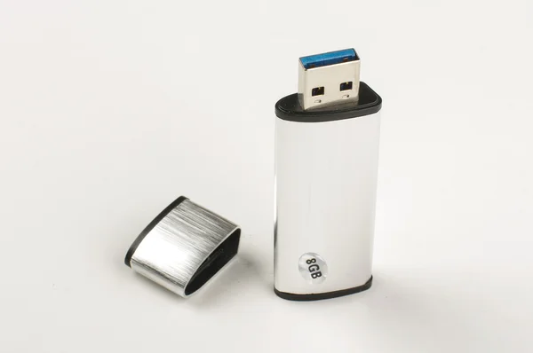 Grey metalic aluminum flash pen drive isolated on the bright background — Stock Photo, Image