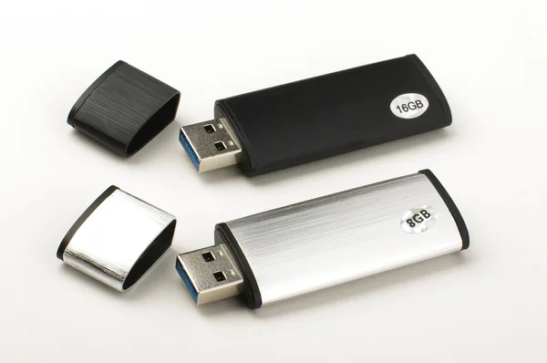 Duas unidades flash USB isoladas no fundo brilhante — Fotografia de Stock