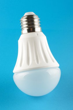 Innovative LED light lamp isolated on the blue background clipart
