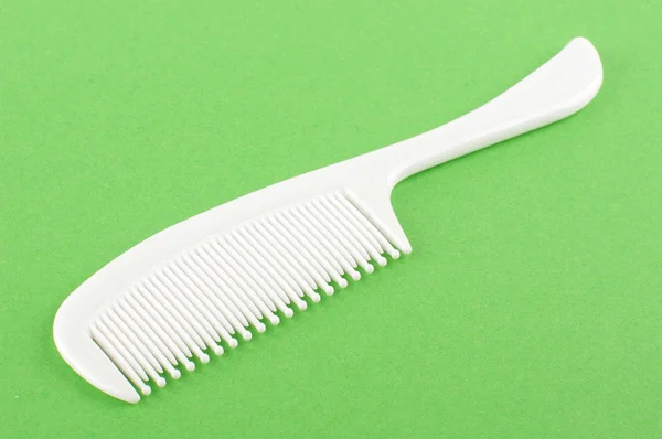 Baby hair comb isolated on the green background — Stock Photo, Image