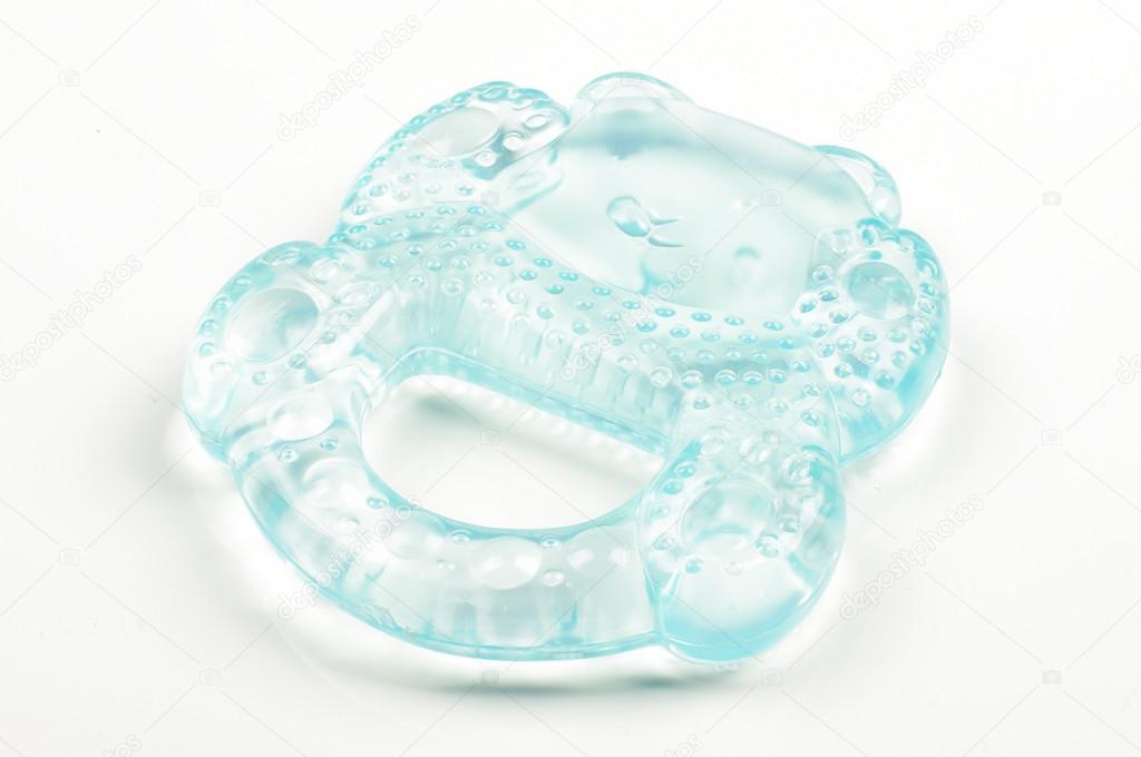 Blue silicone teether and soother for babies isolated on bright background