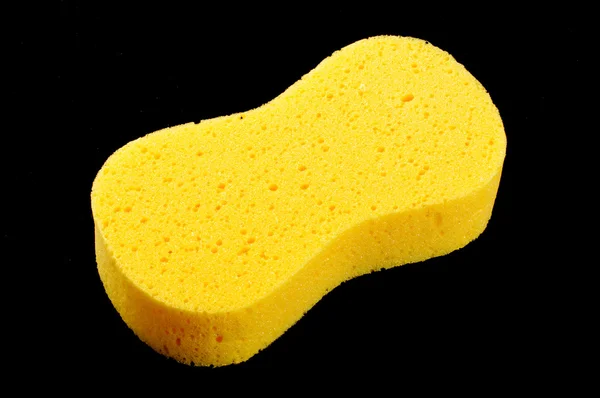 Yellow body care sponge isolated on the black background — Stock Photo, Image