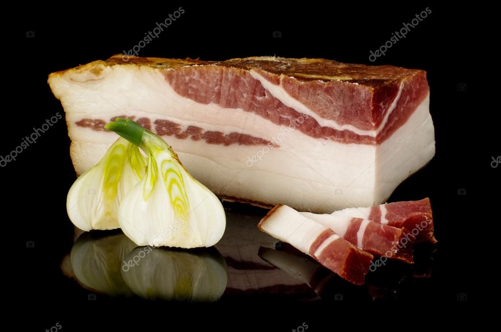 Smoked pork fat or salo on the dark reflective surface Stock Photo by