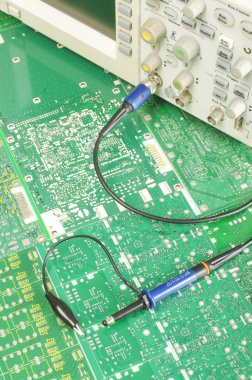 Electronics ocilloscope probe on the printed circuit boards clipart