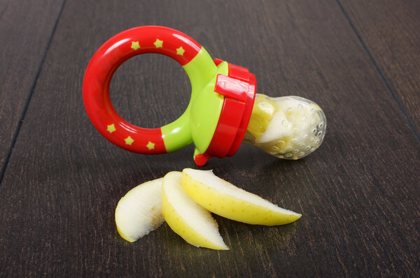 Baby feeding pacifier isolated on the black background