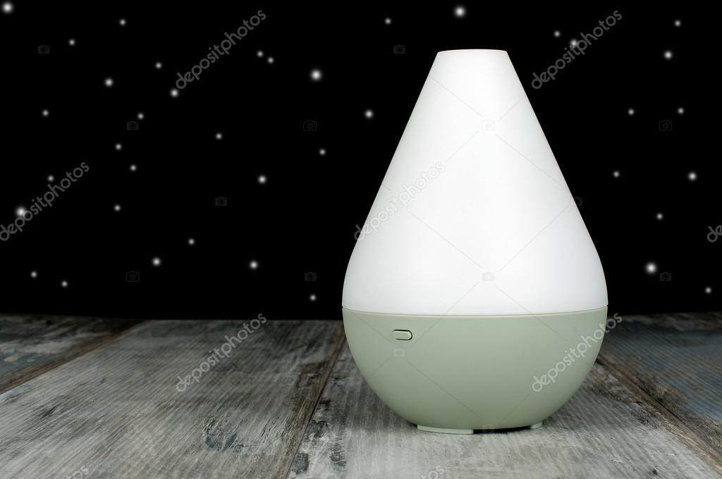 Air humidifier on the aged wooden background