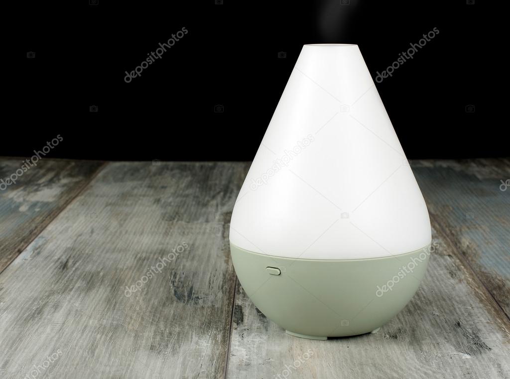 Air humidifier on the aged wooden background