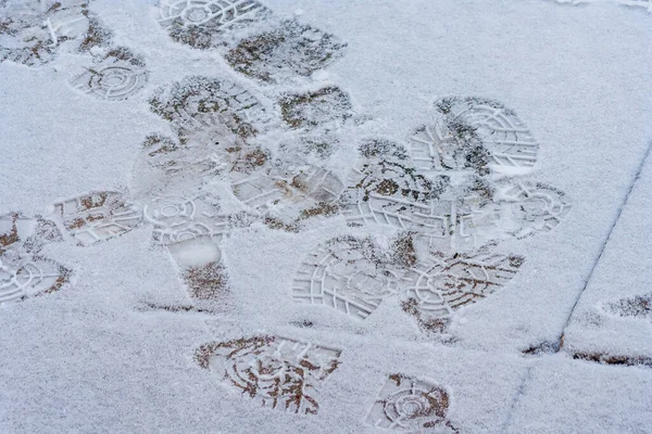 雪の中で多くの足跡 雪の中を歩く危険 冬の地面に多くの足跡 靴跡屋外散歩 — ストック写真