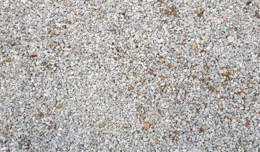 Çakıl dokusu. Çakıl taşı arka planı. Açık gri küçük kayalar. Üst görünüm 