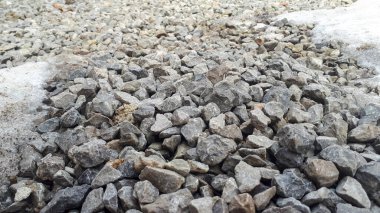 Melting snow on gravel road. Small gravel texture pattern. Rock ground clipart