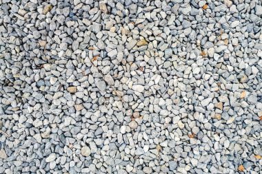 Yakın çekim çakıl dokusu kalıbı. Gri doğal yol geçmişi. Küçük taş kayaların üst görüntüsü