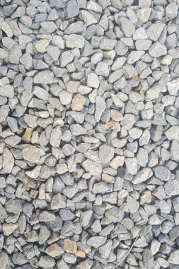 Çakıl taşı döşeme desenli yüzey dokusu. Dış malzemelere yakın çekim. Küçük yol taşı arka planı, koyu çakıl taşı taş dokusu