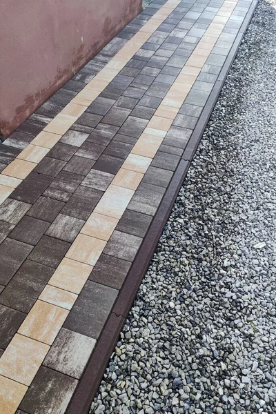 laying paving stones on the pavement with tools. stone block sidewalk. Road paving, construction, sidewalk repair