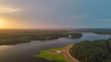 Gün batımında yemyeşil ormanlarda süzülen sakin bir nehrin havadan görünüşü doğanın güzelliğini ve manzaranın dingin çevresini gözler önüne seriyor..