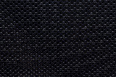 Siyah örgü kumaşına yakın çekim. Karmaşık desenler ve doku. Bu malzeme moda ve endüstriyel tasarımlar için ideal havalandırma ve stil sağlar..