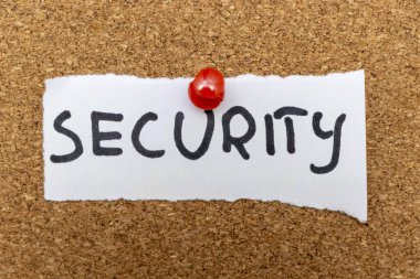 El yazısıyla yazılmış bir kelime. Güvenlik mantar panoya tutturulmuş. Güvenlik ve savunmayı temsil ediyor. Güvenlik yönetimi ve güvenlik hizmetleriyle ilgili konular için ideal.