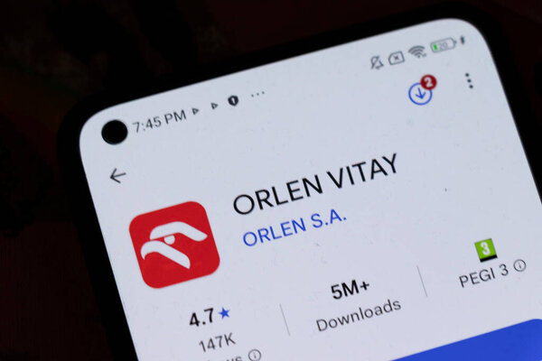Warsaw Poland - November 6 2025: A close-up view of a smartphone screen displaying the ORLEN VITAY app featuring its logo rating and download statistics.